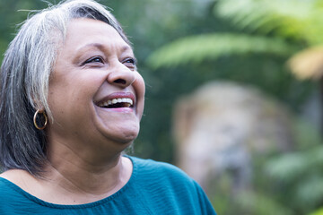 In garden, Smiling senior woman enjoying outdoor hangout, feeling happy and relaxed, copy space