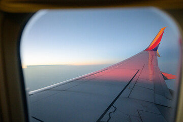 airplane in the sky with blue, red and yellow