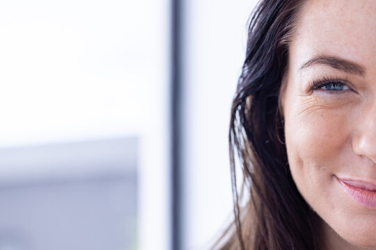 At home, Smiling woman showing half of her face with close-up view, copy space