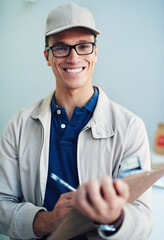 Portrait, courier service and delivery man in warehouse with clipboard for online order shipping. Male person, employee and happiness in store with cargo for transport, freight or ecommerce logistics