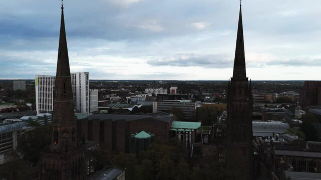 Camera panning over coventry city centre showing coventry cathedral and university buildings