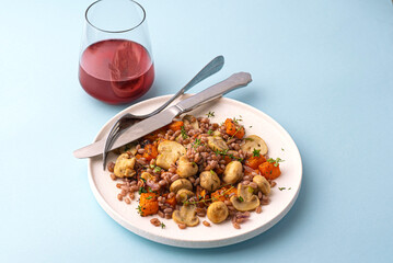 Pearl Barley Porridge or Italian Orzotto with mushrooms, baked pumpkin and thyme, aromatic herbs. Autumn and winter healthy Orzotto, whole grain, barley provides fiber, vitamins, minerals, front view