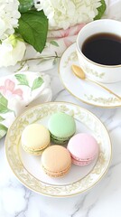 Delicate macarons in pastel colors are arranged on a fine plate beside a coffee cup, presenting a charming morning setup on a marble table adorned with a floral napkin