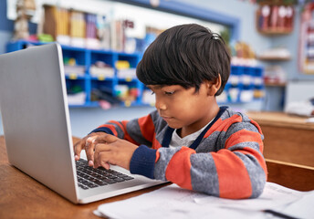 Laptop, kids and boy in classroom for lesson in growth, child development and technology for...