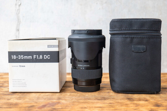 Brand new 18 35mm camera lens standing upright with box and case