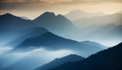 Fototapeta premium Misty Mountains at Dawn, Shrouded in Fog and Illuminated by Soft Light