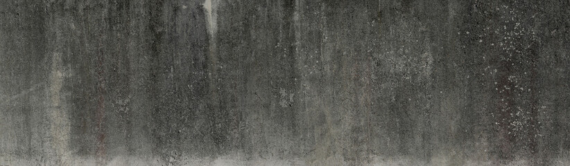 Panoramic texture of an aged dark concrete wall, in gray tones