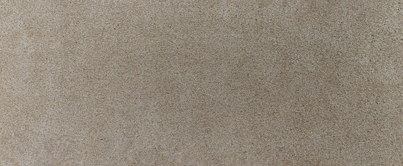 Beige concrete wall texture, grainy and rough surface