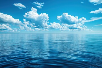 Obraz premium Serene ocean view with clear blue waters and fluffy clouds under a bright sky during midday
