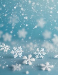 Minimalist winter background with depth of field featuring soft snowflakes on a light blue backdrop