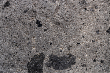 background from natural black tuff stone block