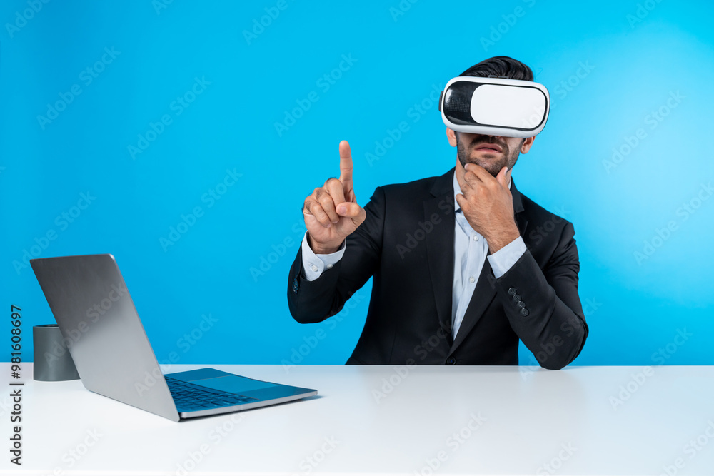 Aufkleber skilled business man looking at data analysis while sitting at table with laptop and wearing vr glas