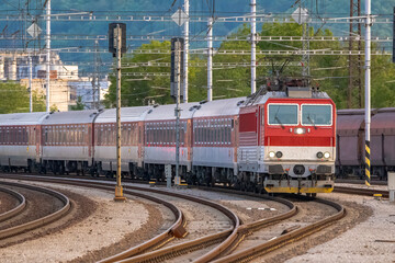 Fototapeta premium A passenger train leaving the railway station.