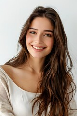 Naklejka premium Portrait of a beautiful young woman smiling and looking on white background