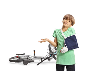 Bicycle accident and boy with a broken arm wearing an arm sling
