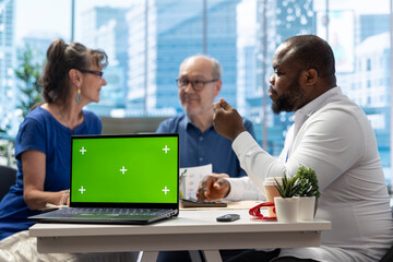 Elderly people consulting with financial expert during meeting in modern office, exploring various retirement and pension plans. Senior couple discuss with advisor about the future.