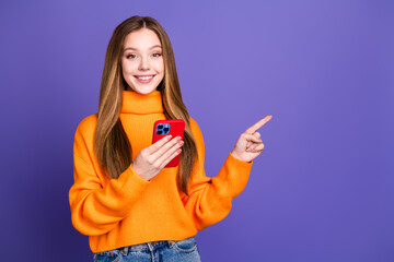 Photo of youth blonde hair cute happy smile girl in using smartphone point finger empty space smm...