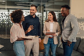 Interracial businesspeople at modern office discussing project.