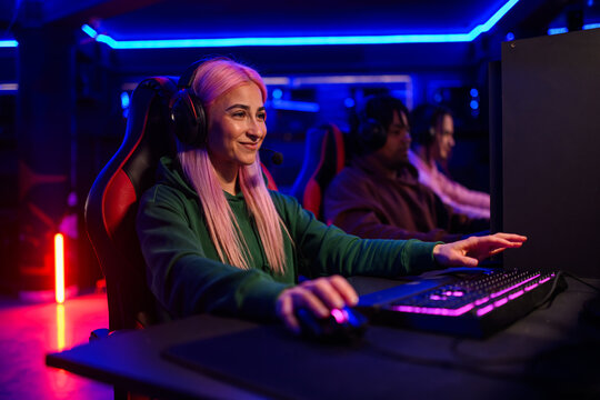 Gamer girl is getting achievement and winning the game in cybercafe
