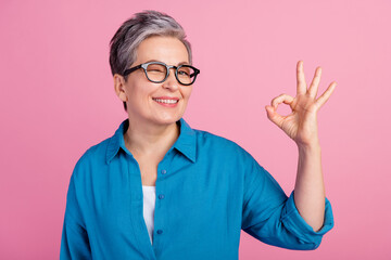 Photo portrait of pretty retired female show okey approve wear trendy blue outfit isolated on pink color background