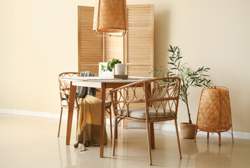 Interior of dining room with table, chairs and folding screen