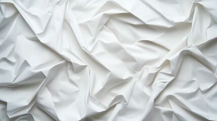 Obraz premium A close-up view of crumpled white fabric showcasing texture and depth, perfect for backgrounds or artistic design.