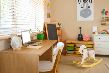 Interior of children's room with table and chalkboard