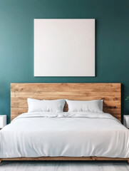 A large white canvas hangs above a bed with white linens.