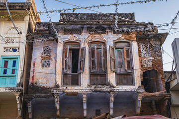 Wooden shutters on a decrepit building in Pushkar.