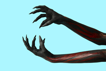 Black witch hands with claws on blue background. Halloween celebration