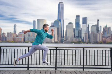 Runner man. Healthy sport. Man running in New York City. Fitness man runner is jogging near Manhattan. Guy running on American street. Man running in New York in sport clothes. Sport wear for runners.