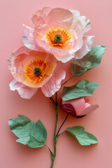 Fototapeta premium A beautifully crafted arrangement of vibrant paper flowers, featuring pink petals and orange centers, elegantly displayed against a soft pastel backdrop, perfect for decoration.