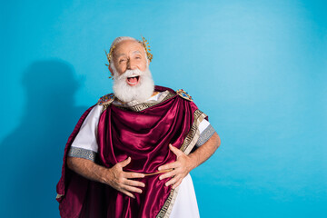 Photo of handsome senior male laughing comedy have fun wear ancient greek god king dress isolated on blue color background
