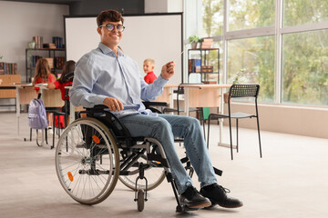 Male teacher in wheelchair with pointer at school