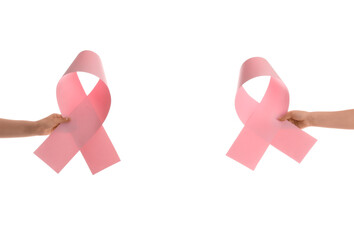 Women holding paper pink ribbons on white background. Breast cancer awareness concept