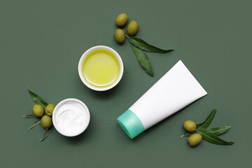 Composition with natural cream, green olives and oil on color background
