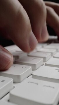 Close-up man typing on computer keyboard with hands and fingers. Macro soft focus dolly shot. Computer programming, text chat online messaging and online marketing business concept.