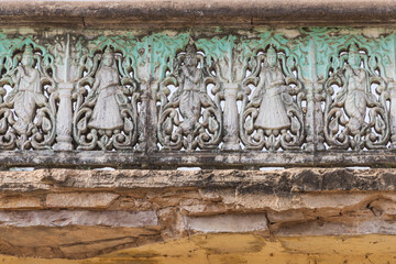 Decorative stone work on a garden wall.