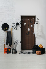 Interior of hallway decorated for Halloween with door, ladder and gift bags