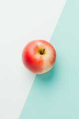 Top view of an apple on a white and light blue background, with hard shadows, in a minimalist style. This is a studio photography product shot with bright light, sharp focus, and professional 