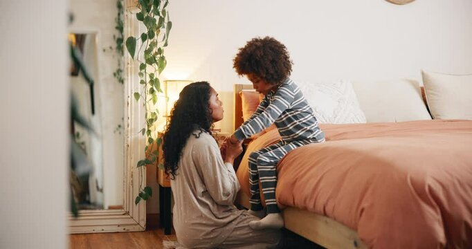 Mother, child and talking on bed with holding hands, restless or getting ready for sleep. Mom, boy or discussion in bedroom for discipline, check behavior or bonding in home with healthy relationship