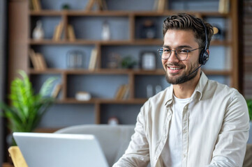 Naklejka premium Smiling customer service representative working remotely with headset and laptop