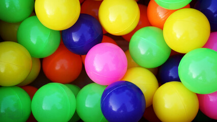 Colorful plastic balls. Green yellow blue orange pink