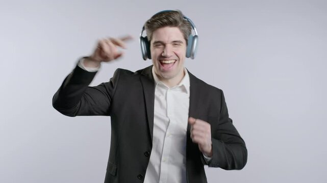 Brunette Positive Businessman Listening Music With Headphones, White Studio