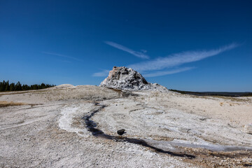 Photograph of the White Dome Geyser in Yellowstone National Park on bright blue sky day