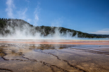 Photograph of hot steam rising from grand prismatic springs in Yellowstone national park.