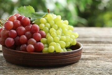 Fresh ripe grapes on wooden table, closeup