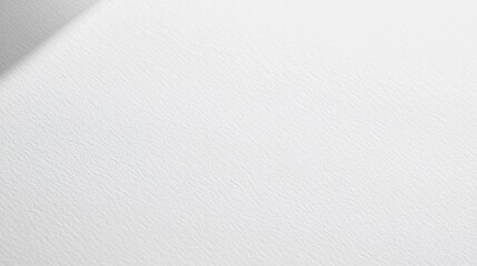 Close up of textured white paper background with light shadow.