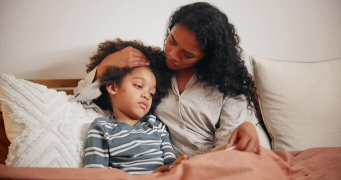 Mother, sick child and bed for healthcare, virus or infection in support or trust at home. Mom, young kid or boy with illness, flu symptom or cold fever in childcare, help or rest for nap in bedroom