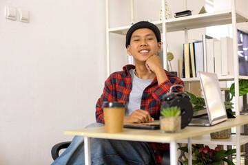 Portrait of Asian freelancer man sitting at home office